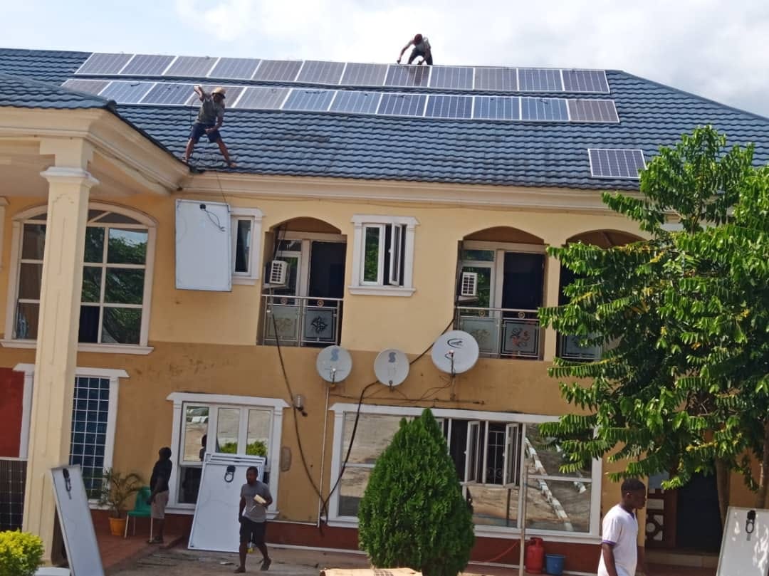 Fortune Solar World technicians installing a large residential rooftop solar array
